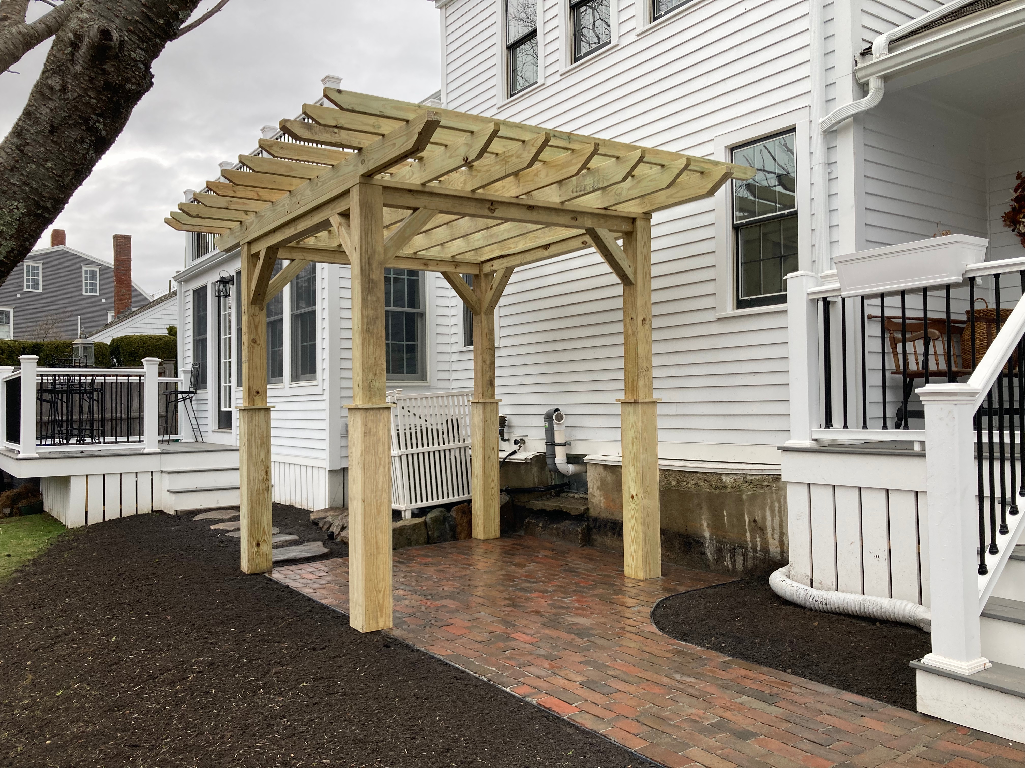 Pergola woodworking custom built small space backyard patio Newbury ma jmj gardens hardscape masonry
