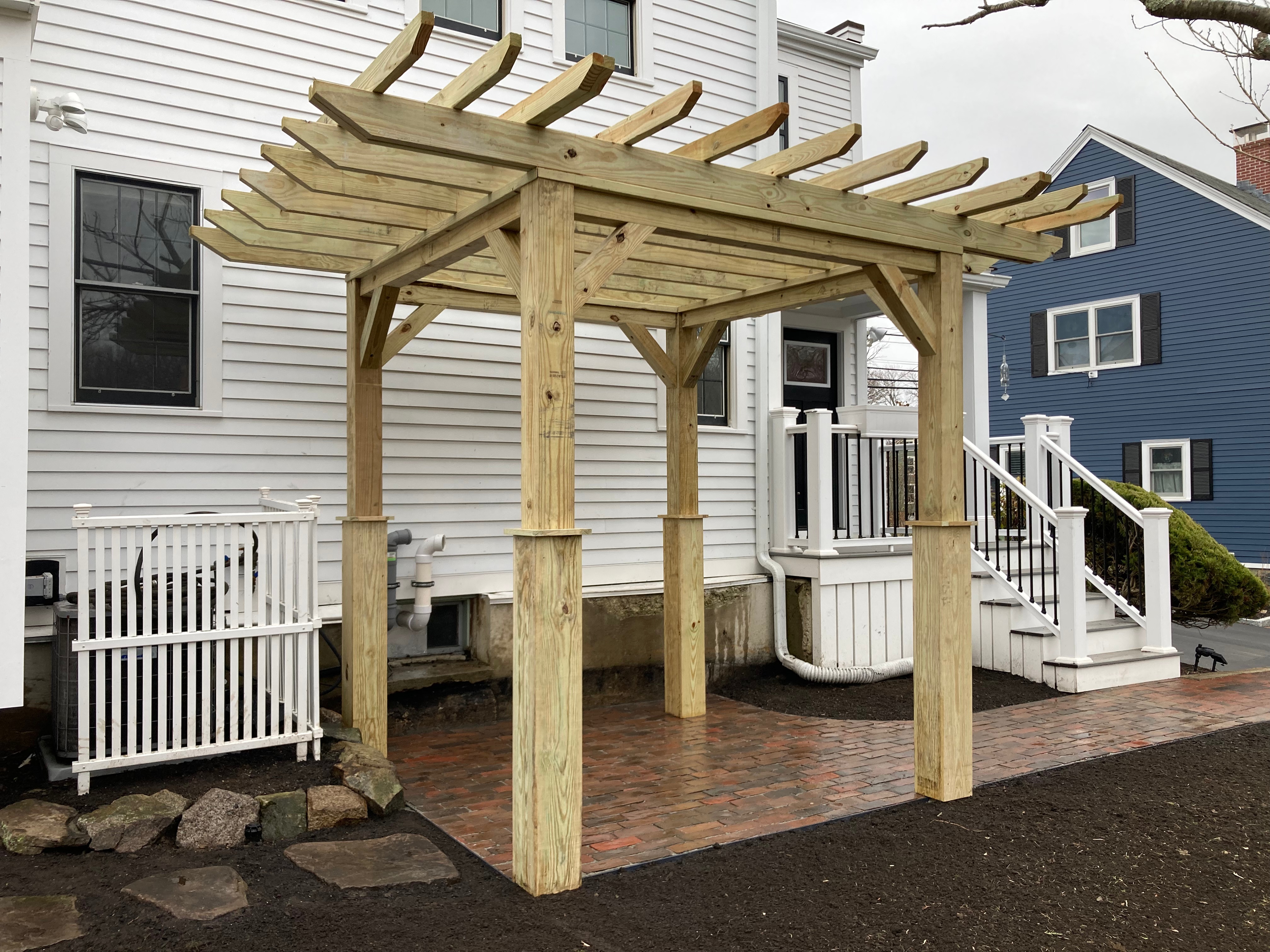 Pergola woodworking custom built small space backyard patio Newbury ma jmj gardens hardscape masonry